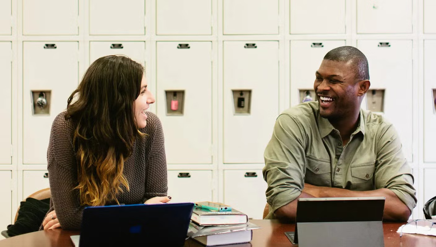 two people chatting and laughing together